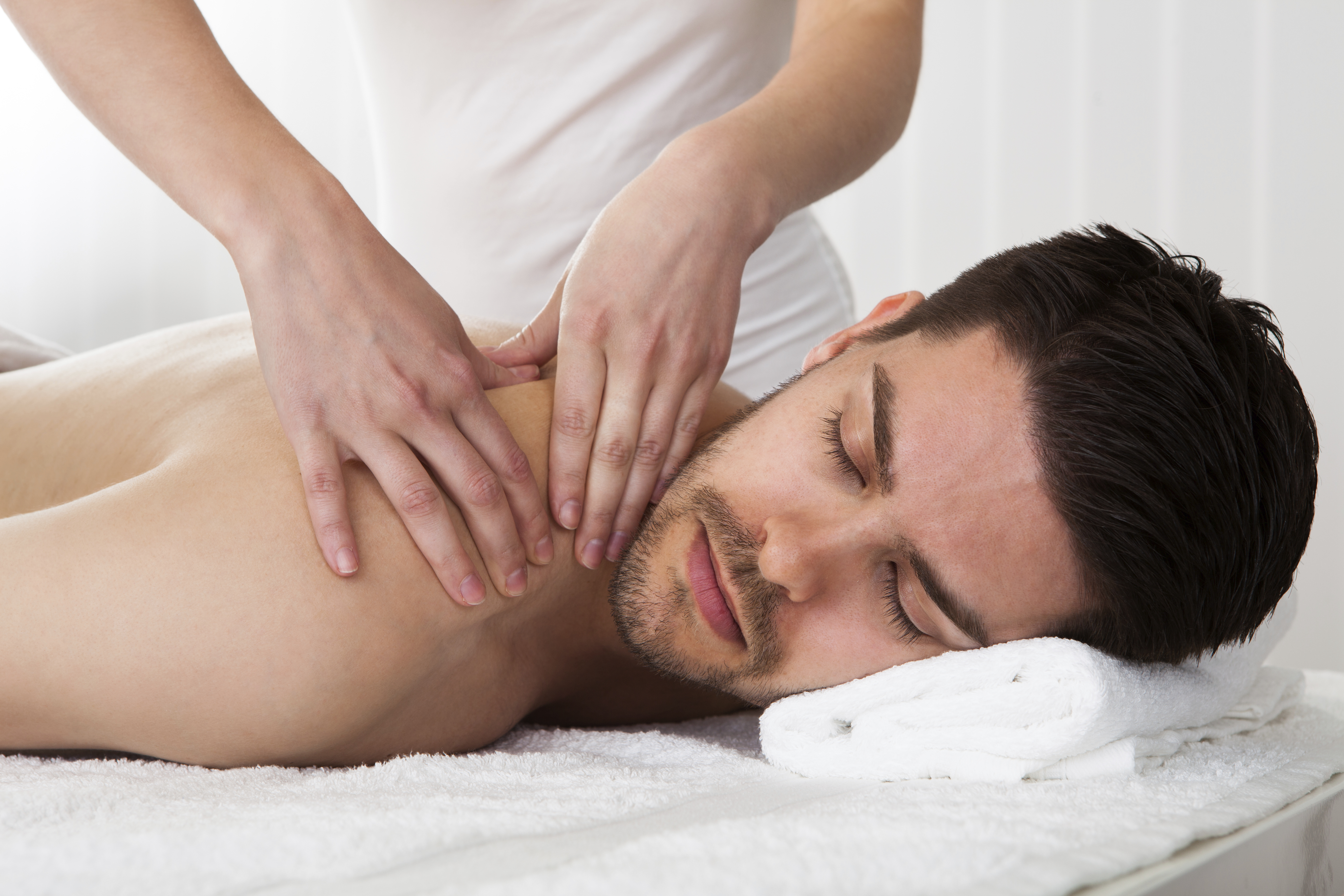 Licensed massage therapist providing back massage in Rockwall, Texas